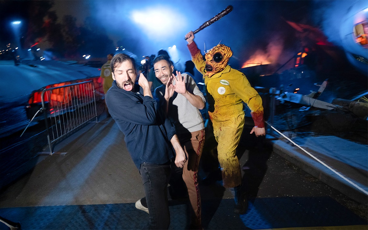 Guests reacting to a costumed performer at Hollywood Horror Nights, Universal Studios Hollywood, Los Angeles.