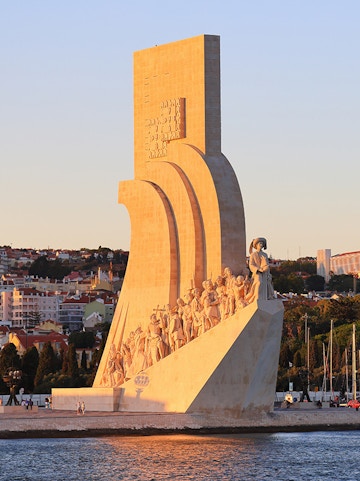 Padrão dos Descobrimentos monument in Lisbon, Portugal, at sunset with statues of explorers.
