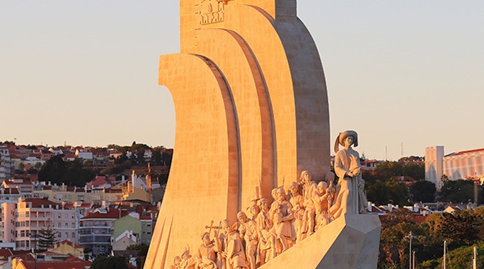 Padrão dos Descobrimentos monument in Lisbon, Portugal, at sunset with statues of explorers.