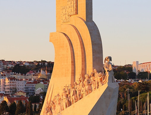 Padrão dos Descobrimentos monument in Lisbon, Portugal, at sunset with statues of explorers.