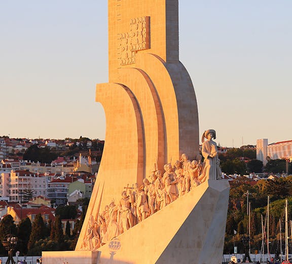 Padrão dos Descobrimentos monument in Lisbon, Portugal, at sunset with statues of explorers.