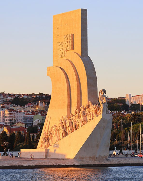 Padrão dos Descobrimentos monument in Lisbon, Portugal, at sunset with statues of explorers.