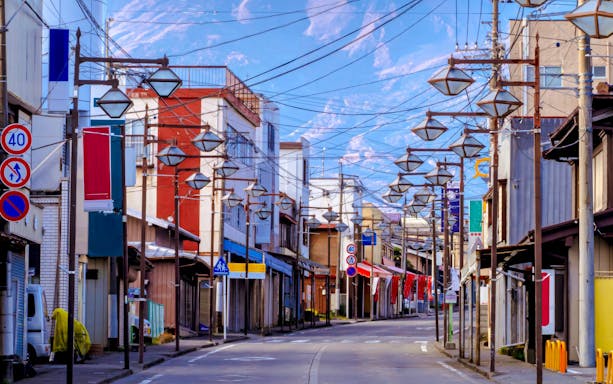 Fujihonmachi street with traditional buildings and overhead lanterns in Japan.