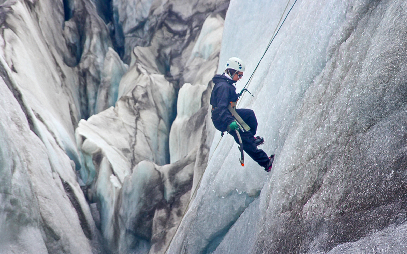 Guest ice climbing on a glacier in Skaftafell, Iceland.