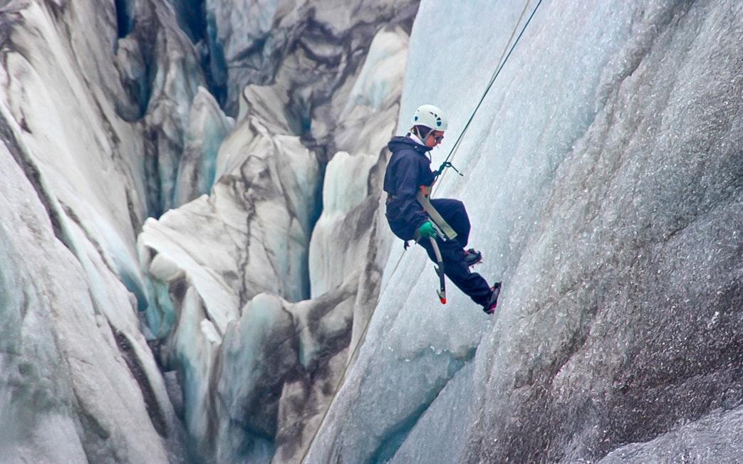 Guest ice climbing on a glacier in Skaftafell, Iceland.