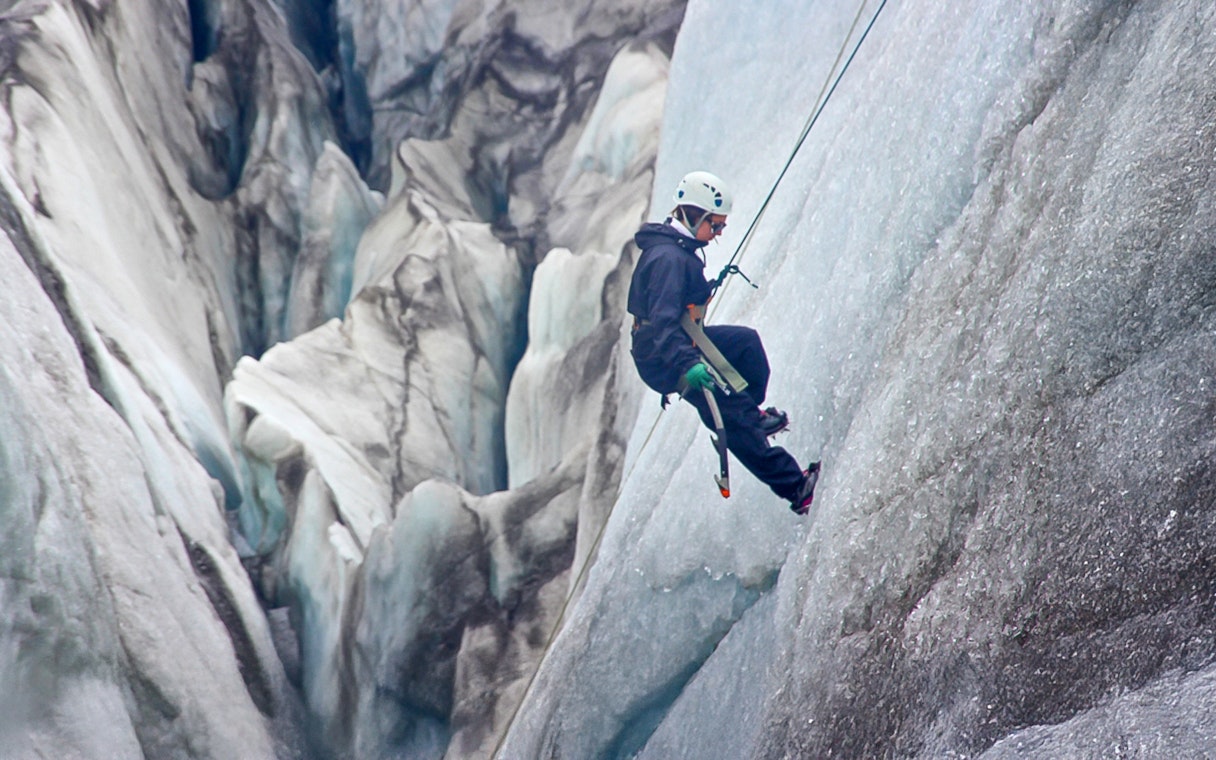 Guest ice climbing on a glacier in Skaftafell, Iceland.