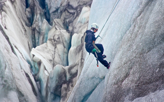 Guest ice climbing on a glacier in Skaftafell, Iceland.