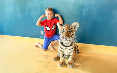 Child posing with tiger cub at Tiger Park Pattaya.