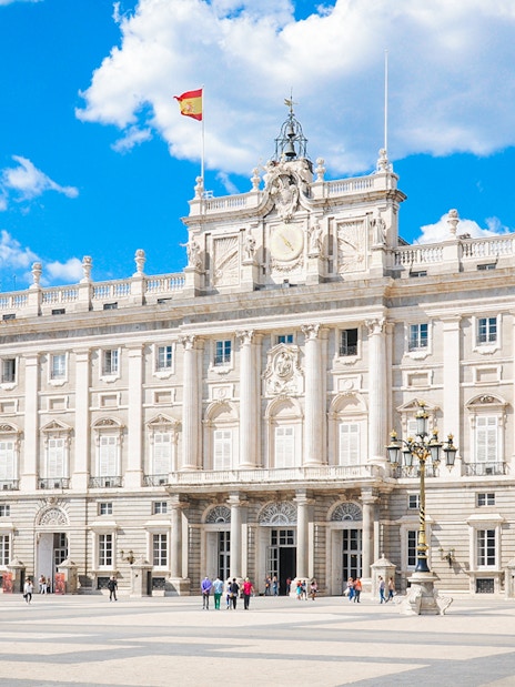 Tourists at the Royal Palace of Madrid courtyard, Spain, with skip-the-line access.
