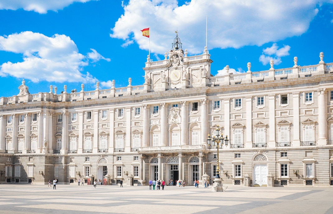 Tourists at the Royal Palace of Madrid courtyard, Spain, with skip-the-line access.