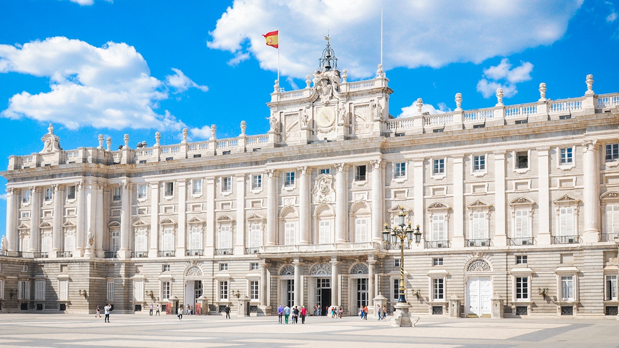 Tourists at Royal Palace of Madrid viewing Royal Collections Gallery with skip-the-line tickets.