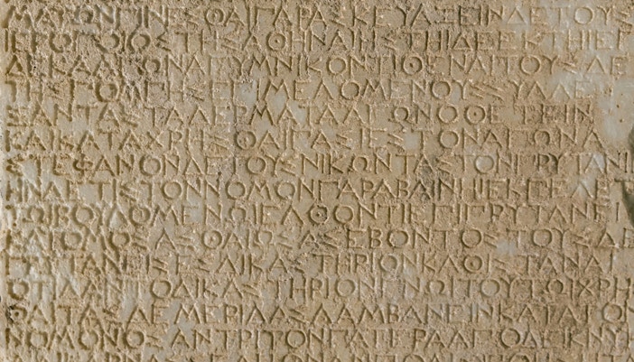 Ancient Greek stone inscription detailing historical decrees.