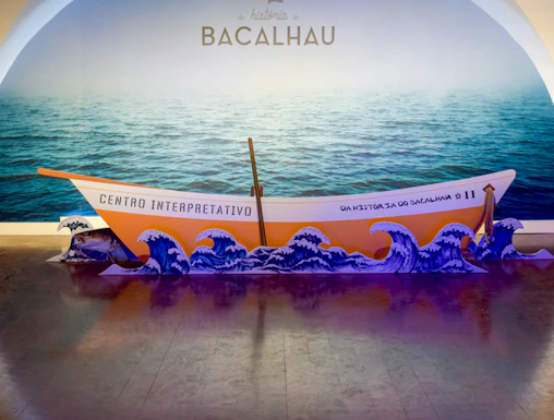 Codfish History Interpretation Centre exhibit with boat and ocean backdrop.