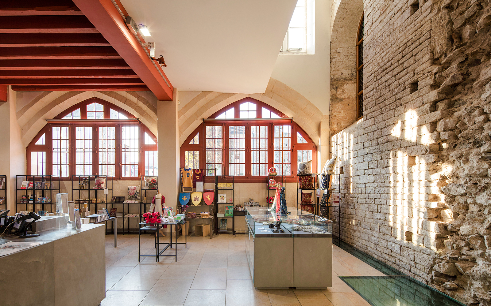 Gift shop interior at Abbaye de Cluny, Lyon, France, featuring medieval-themed merchandise.