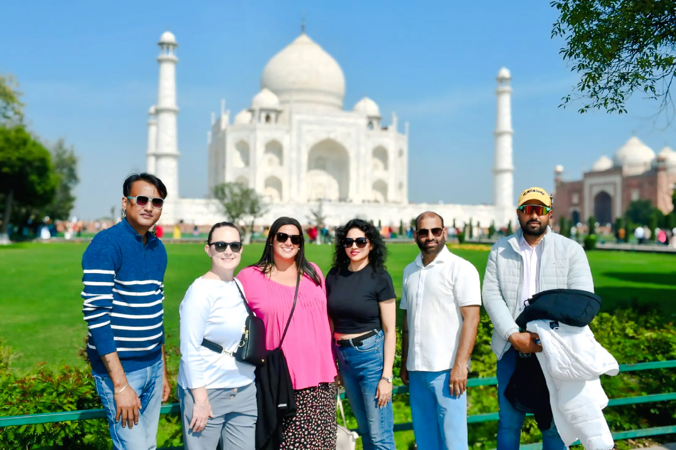 Group of tourists in front of the Taj Mahal during Agra tour.