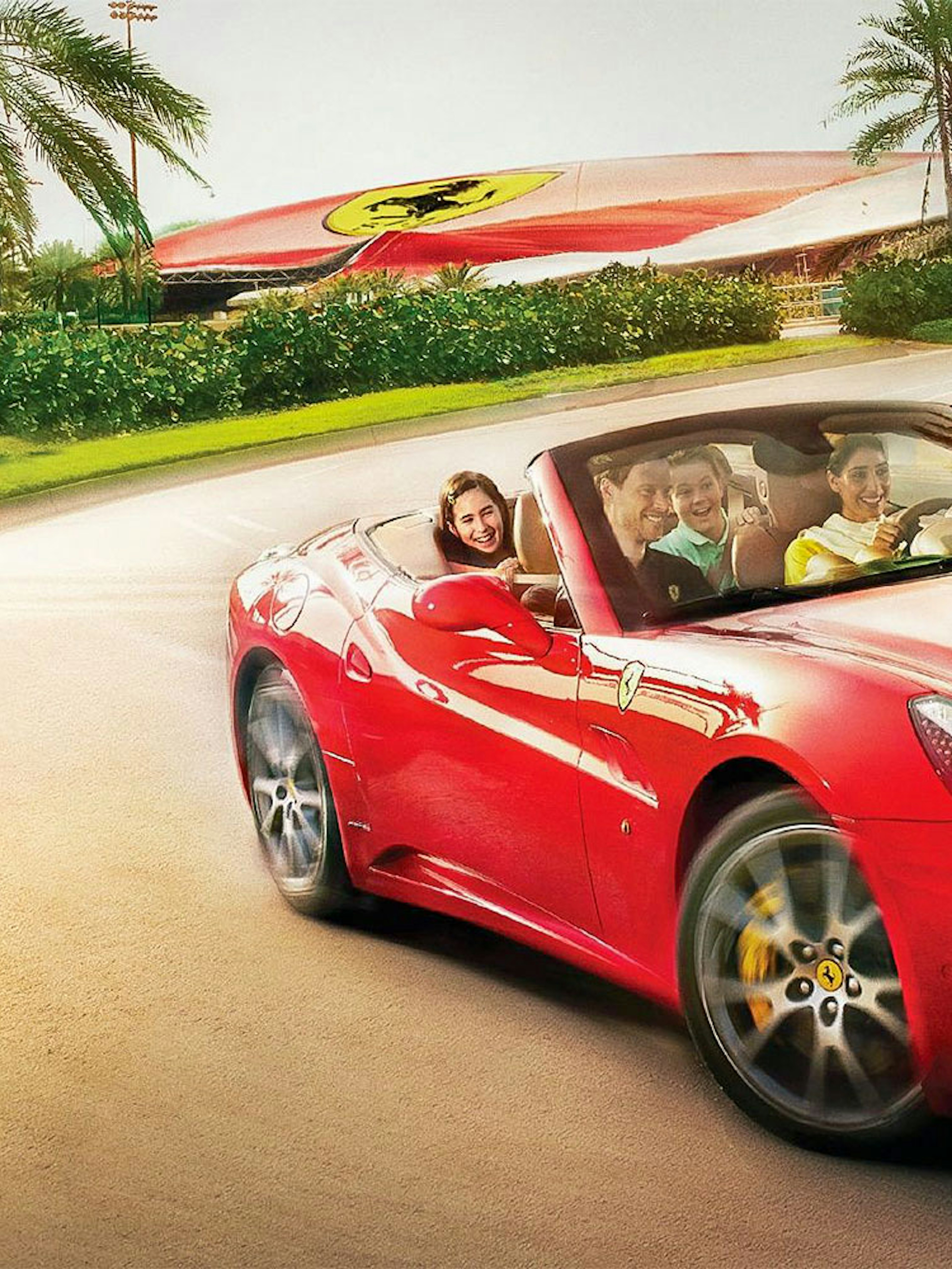 Visitors driving a red Ferrari at Ferrari World Abu Dhabi.