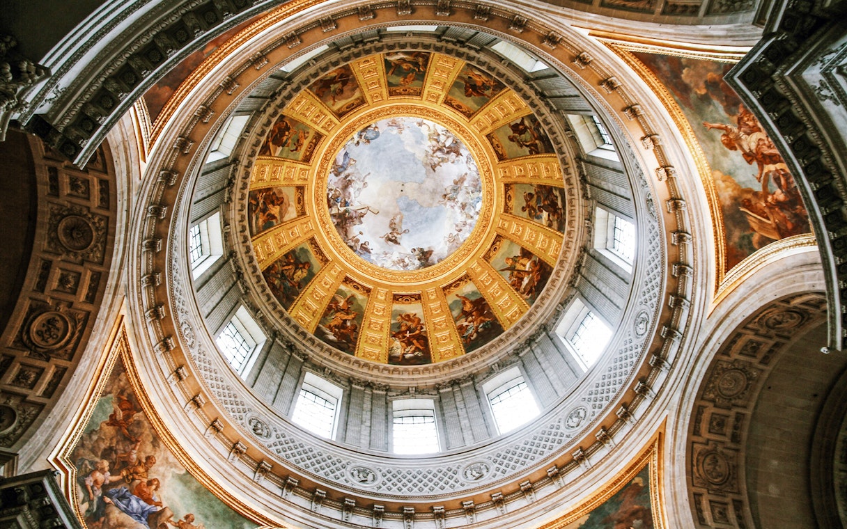 Dome of Les Invalides with intricate frescoes and golden details, Paris, France.