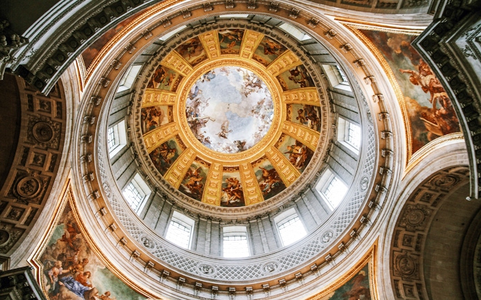 Dome of Les Invalides with intricate frescoes and golden details, Paris, France.