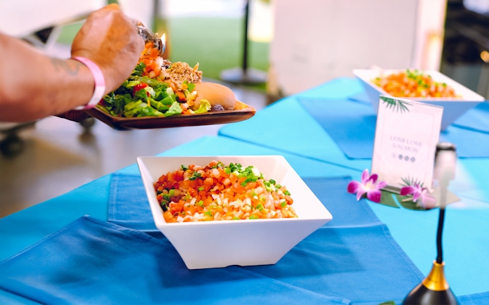 Serving traditional Hawaiian dishes at Moana Luau, Hawaii.