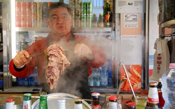 Vendor preparing traditional street food in Florence during a guided tour.