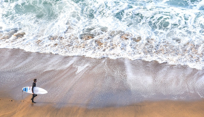 Surfers riding waves at Torquay Surf Beach, Victoria, Australia.