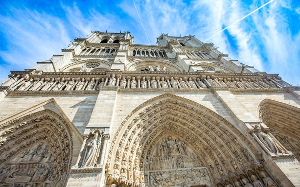 Notre Dame Cathedral facade in Paris, featuring detailed stone carvings.