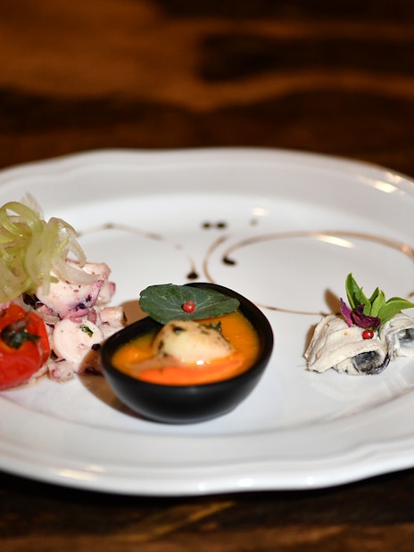 Seafood appetizer on a white plate during Galleon Dinner Cruise in Venice.