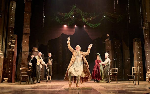 Stage performance of "A Christmas Carol - A Ghost Story" with actors in period costumes.