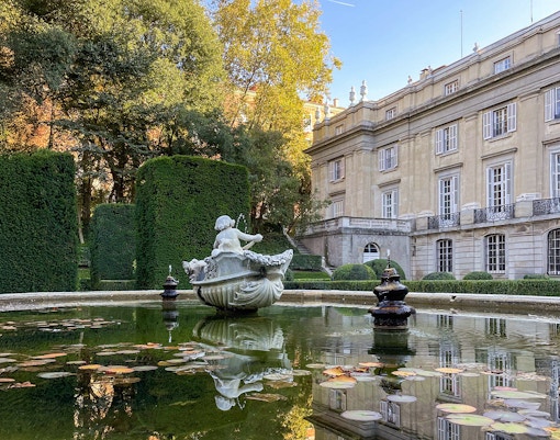 Liria Palace Gardens in Madrid with manicured hedges and historic architecture in the background.