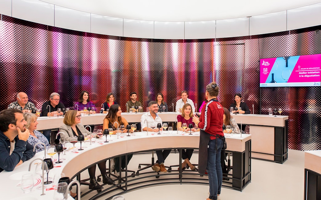 Visitors participating in a wine tasting session at Cité du Vin museum, Bordeaux, France.