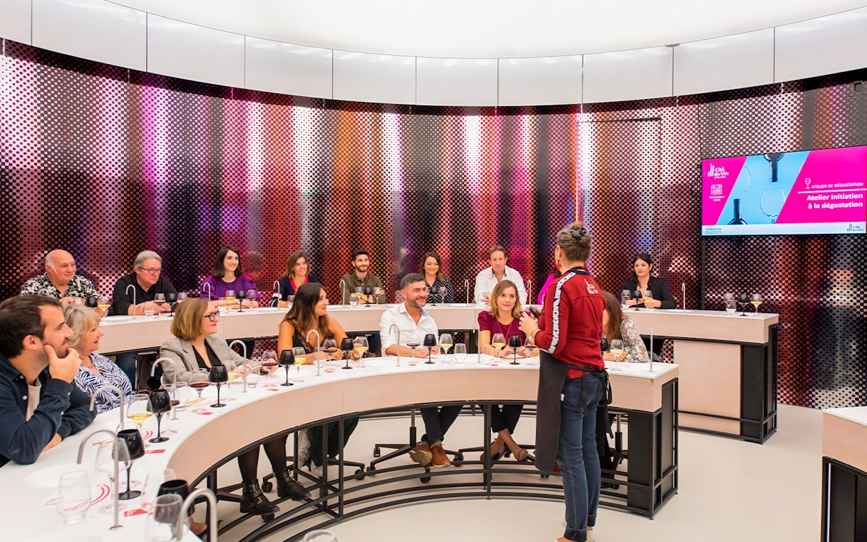 Visitors participating in a wine tasting session at Cité du Vin museum, Bordeaux, France.