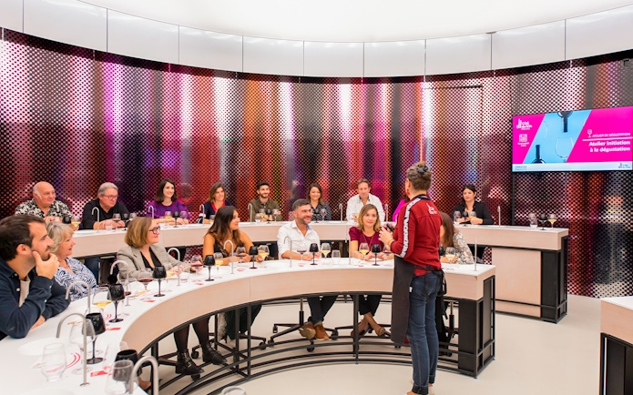 Visitors participating in a wine tasting session at Cité du Vin museum, Bordeaux, France.