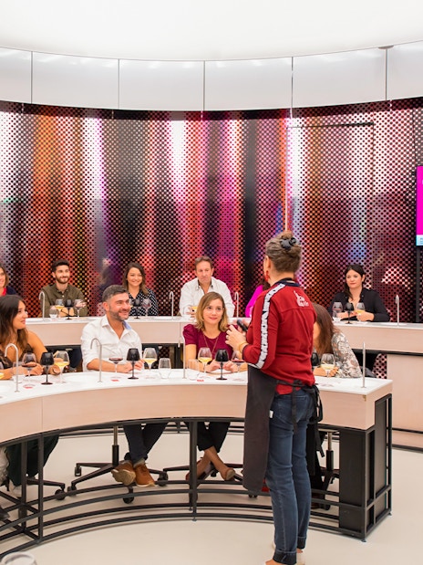 Visitors participating in a wine tasting session at Cité du Vin museum, Bordeaux, France.
