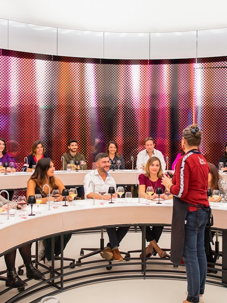 Visitors participating in a wine tasting session at Cité du Vin museum, Bordeaux, France.