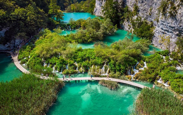 Aerial view of Plitvice Lakes with wooden walkways and turquoise water during a private day tour from Split.