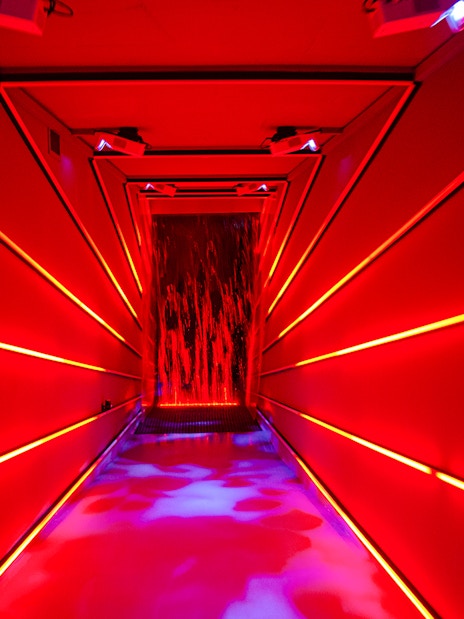 Immersive red-lit hallway at Remastered audiovisual experience, Rotterdam.