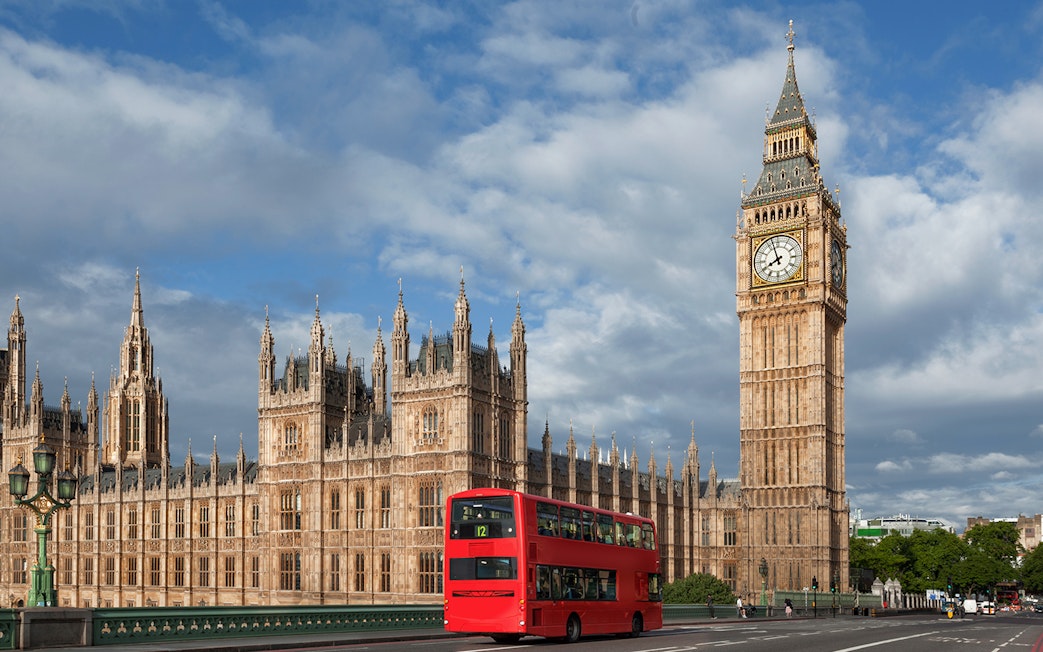 Big Ben and Palace of Westminster with red double-decker bus, London.