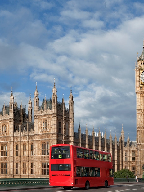 Big Ben and Palace of Westminster with red double-decker bus, London.