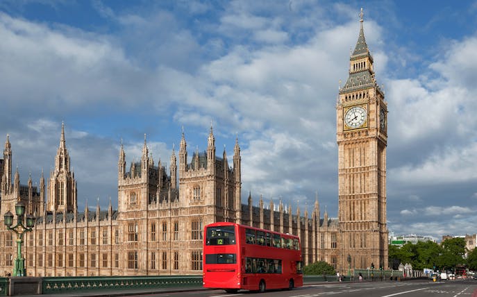 Big Ben and Palace of Westminster with red double-decker bus, London.