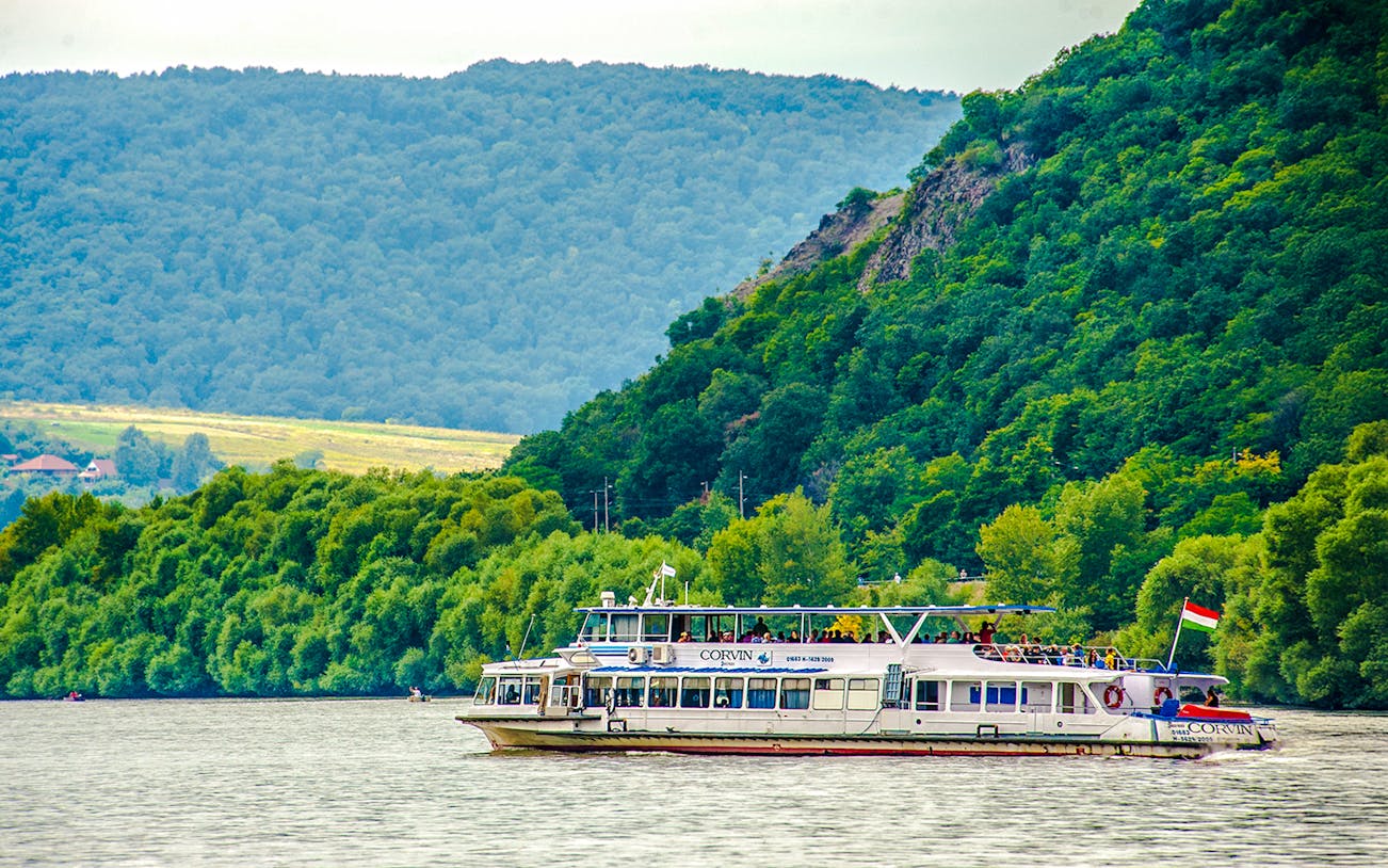 Boat cruising on the Danube River during Full Day Visegrád Cruise with Medieval Show & Banquet.