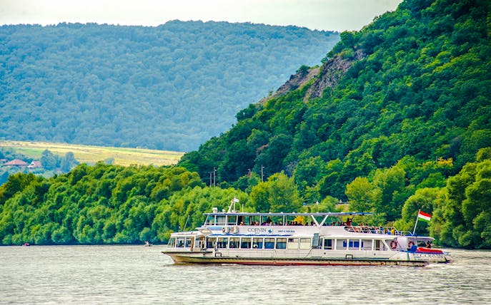 Boat cruising on the Danube River during Full Day Visegrád Cruise with Medieval Show & Banquet.
