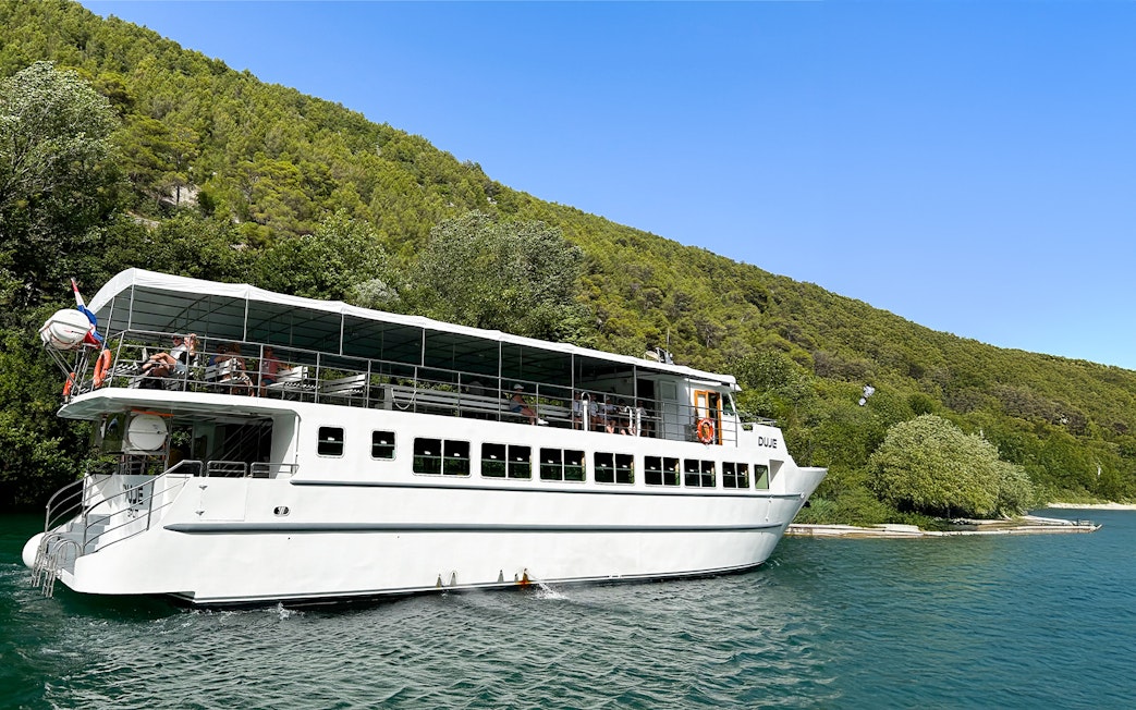 Boat with guests cruising through Krka National Park, Croatia.