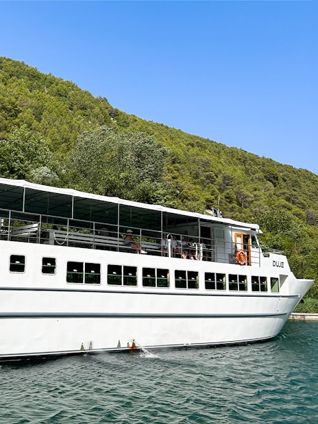 Boat with guests cruising through Krka National Park, Croatia.