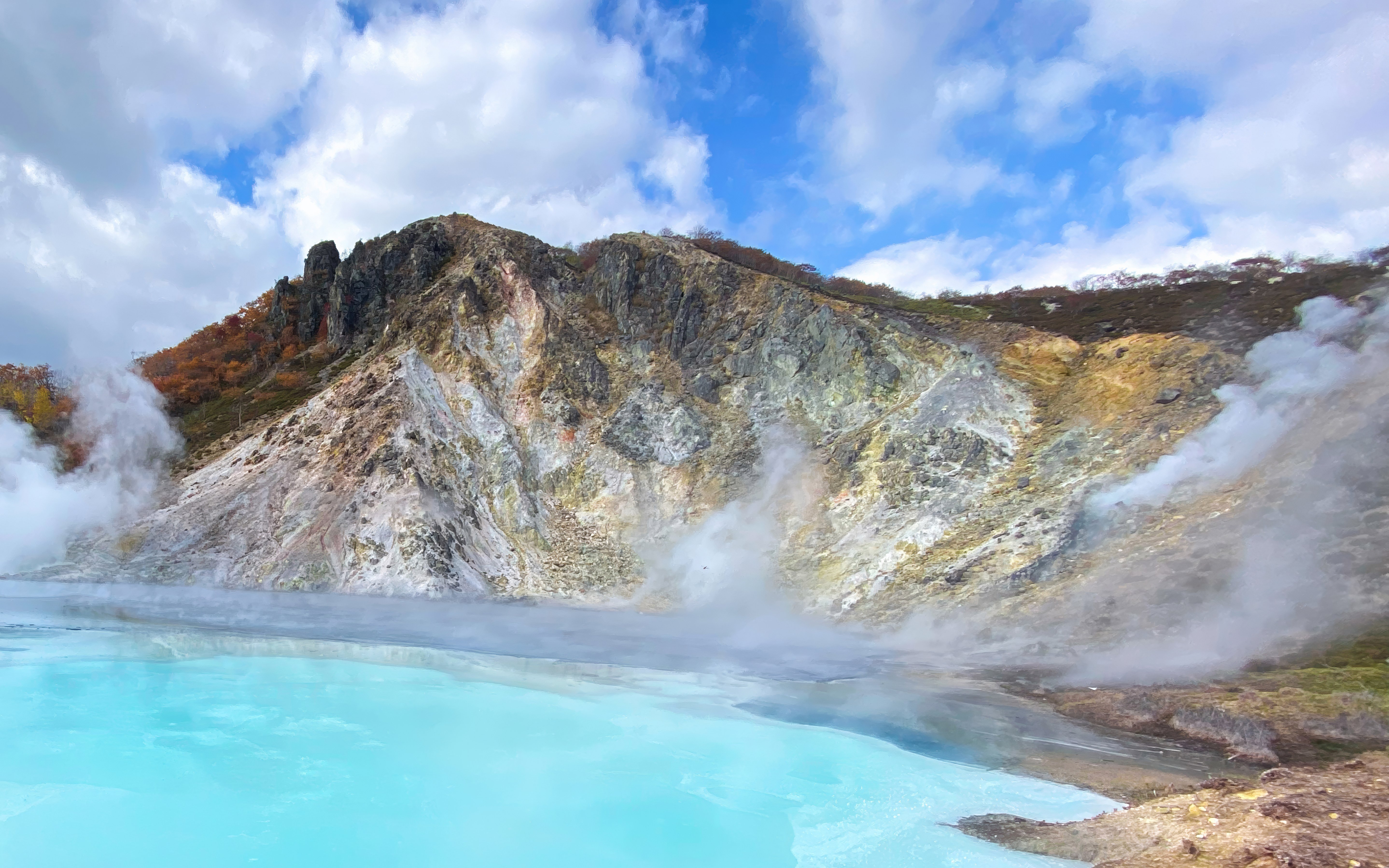 Geothermal steam rising from a hot spring in Shikotsu-Toya National Park, Japan.