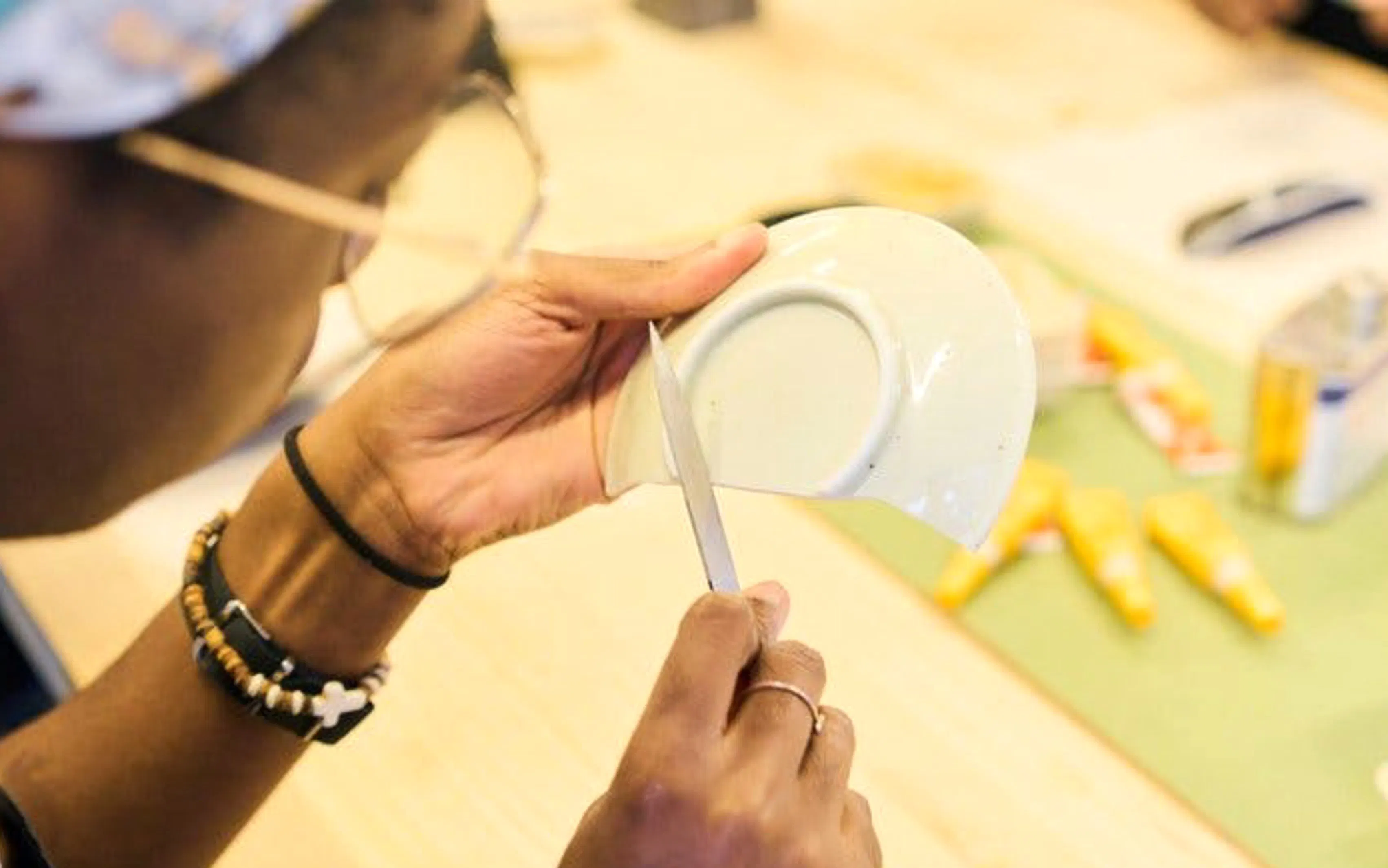 Person repairing pottery at Kintsugi workshop in Shinjuku, Tokyo.