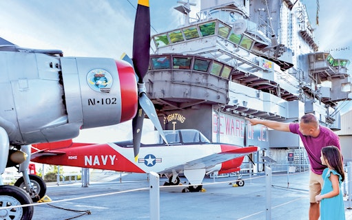 Father and daughter viewing aircraft at Intrepid Museum, New York City.