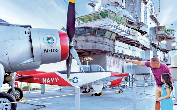 Father and daughter viewing aircraft at Intrepid Museum, New York City.