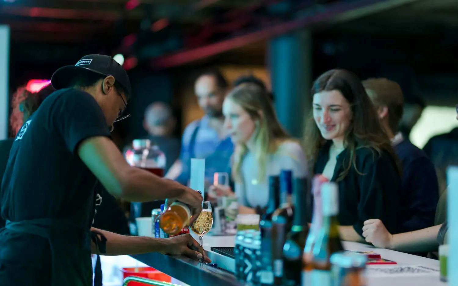 Guests enjoying drinks at the bar inside ARTECHOUSE DC.
