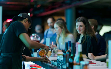 Guests enjoying drinks at the bar inside ARTECHOUSE DC.