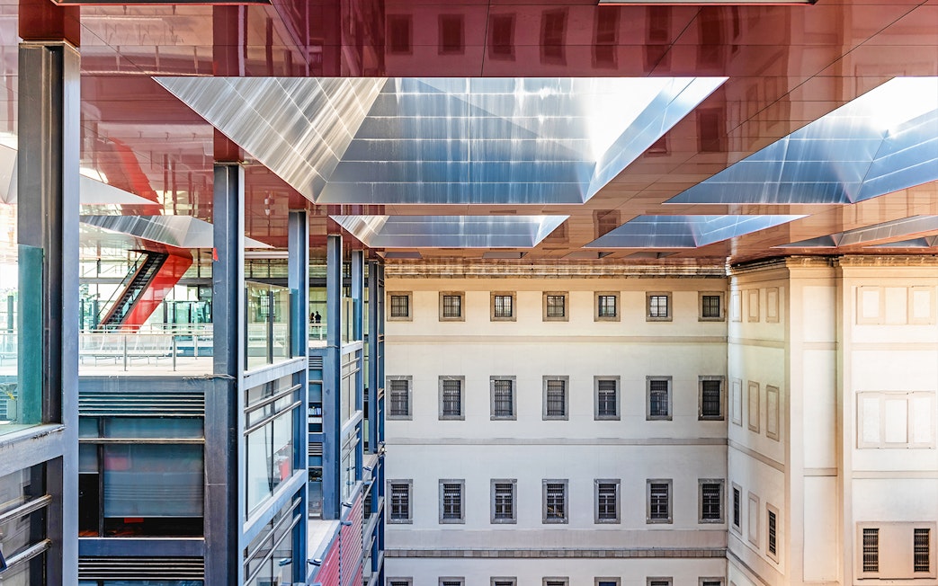 Visitors at Reina Sofia Museum's modern architecture in Madrid, Spain.